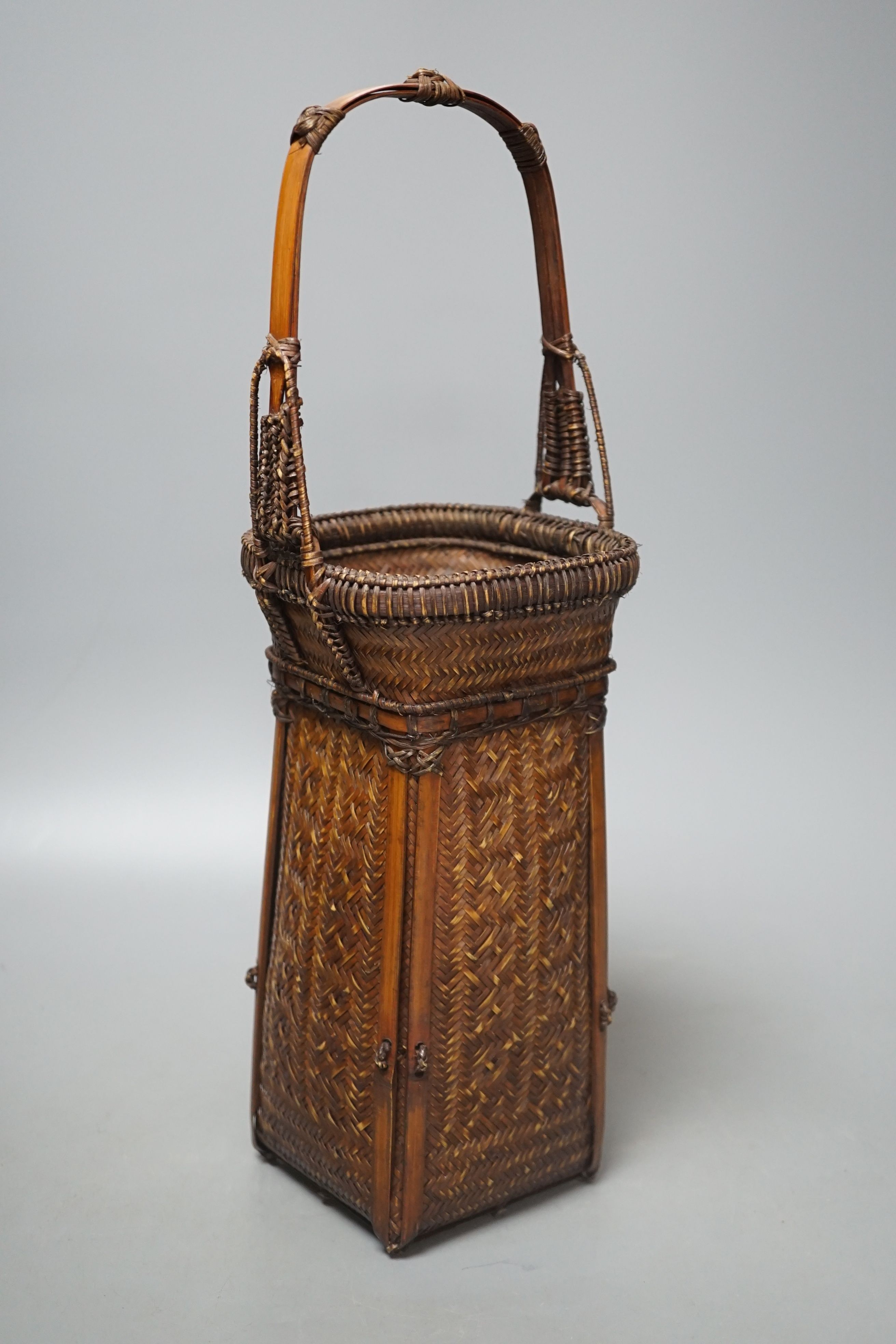 A Japanese wicker Ikebana flower basket, 38.5 cms high.